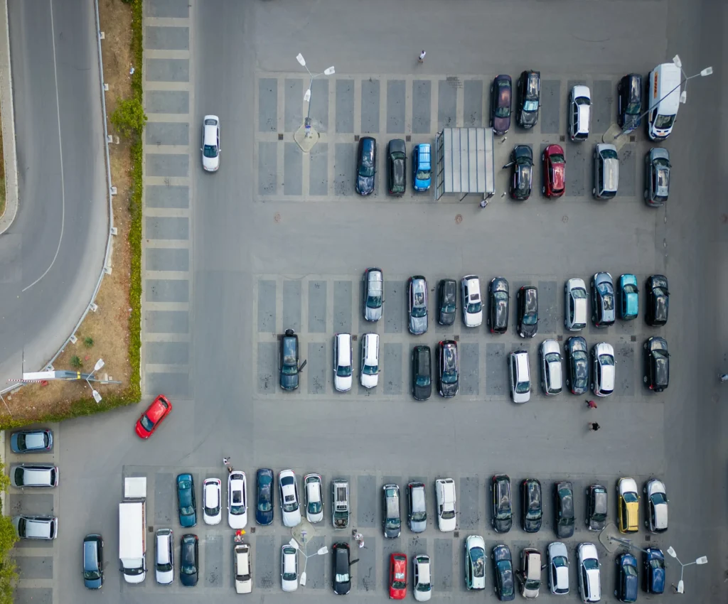 Aerial view of a busy commercial car park and surrounding access roads, ideal for cleaning and maintenance services.