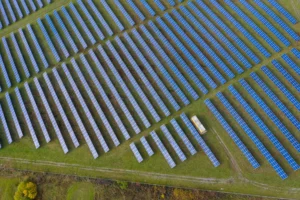 Drone image of hundreds of ground-mounted solar panel strings at a UK solar farm maintained by Roundhouse UK.