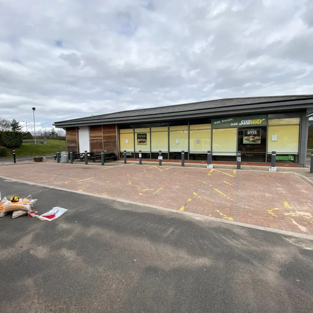 Freshly pressure-washed and re-sanded block paving outside a Subway store in Guisborough, restored by Roundhouse UK’s professional cleaning team.