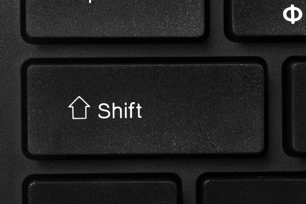 Close-up of a black keyboard shift key, symbolising the transition from reactive cleaning to a proactive, planned preventative maintenance strategy.